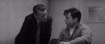 Movie still from “In Cold Blood” (1967), directed by Richard Brooks – A man and a man talking to each other in a room; Close Up shot, Over the shoulder angle