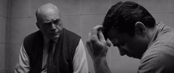 Movie still from “In Cold Blood” (1967), directed by Richard Brooks – A man with a beard is looking at another man's hair; Close Up shot, Over the shoulder angle