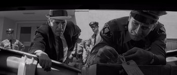 Movie still from “In Cold Blood” (1967), directed by Richard Brooks – A black and white photo of a man in a suit and tie; Close Up shot, Low angle