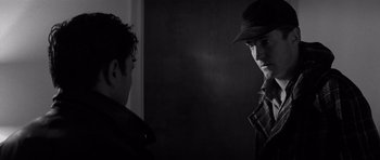 Movie still from “In Cold Blood” (1967), directed by Richard Brooks – A man wearing a hat looking at another man in a hat; Close Up shot, Over the shoulder angle