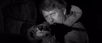Movie still from “In Cold Blood” (1967), directed by Richard Brooks – A black and white photo of a man holding a gun; Close Up shot, Low angle