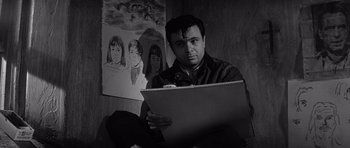Movie still from “In Cold Blood” (1967), directed by Richard Brooks – A black and white photo of a man holding a book; Close Up shot, Low angle