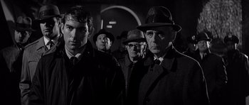 Movie still from “In Cold Blood” (1967), directed by Richard Brooks – Black and white photograph of a group of men wearing hats; Medium shot, Low angle