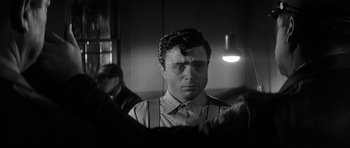 Movie still from “In Cold Blood” (1967), directed by Richard Brooks – A black and white photo of a man in a tie; Close Up shot, Over the shoulder angle