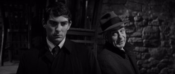 Movie still from “In Cold Blood” (1967), directed by Richard Brooks – A man in a suit and a man in a hat; Close Up shot, Over the shoulder angle