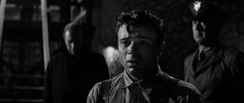 Movie still from “In Cold Blood” (1967), directed by Richard Brooks – A black and white photo of a man with a beard; Close Up shot, Over the shoulder angle