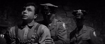 Movie still from “In Cold Blood” (1967), directed by Richard Brooks – A group of men standing next to each other; Medium shot, Low angle