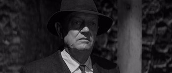 Movie still from “In Cold Blood” (1967), directed by Richard Brooks – An older man wearing a hat and a suit; Close Up shot, Over the shoulder angle