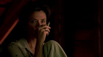 Movie still from “In Dreams” (1999), directed by Neil Jordan – A woman holding a cell phone up to her ear; Close Up shot, Low angle