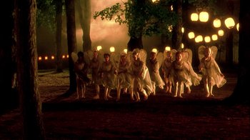 Movie still from “In Dreams” (1999), directed by Neil Jordan – A group of people dressed as angels in a forest; Extreme Wide shot, High angle