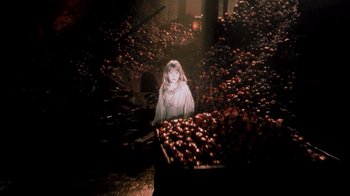 Movie still from “In Dreams” (1999), directed by Neil Jordan – A woman standing in front of a pile of apples; Wide shot, High angle