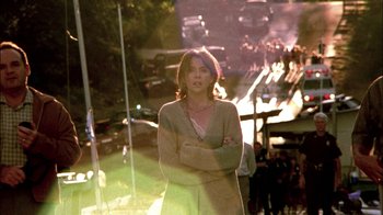 Movie still from “In Dreams” (1999), directed by Neil Jordan – A woman standing in front of a street with traffic lights in the background; Medium shot, Low angle
