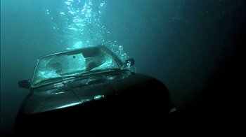 Movie still from “In Dreams” (1999), directed by Neil Jordan – A car is submerged in a body of water; Wide shot, High angle