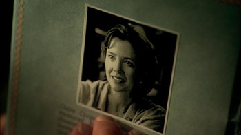 Movie still from “In Dreams” (1999), directed by Neil Jordan – A person holding up a picture of a woman; Extreme Close Up shot, Overhead angle