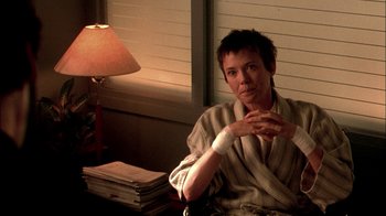 Movie still from “In Dreams” (1999), directed by Neil Jordan – A woman sitting at a table in front of a window; Medium shot, Over the shoulder angle