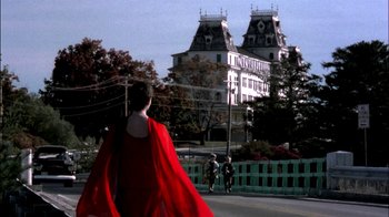 Movie still from “In Dreams” (1999), directed by Neil Jordan – A man in a red cape walking down a street; Extreme Wide shot, Low angle