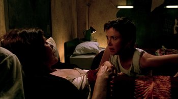 Movie still from “In Dreams” (1999), directed by Neil Jordan – Two people are sitting on a bed in a room; Close Up shot, Over the shoulder angle