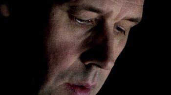 Movie still from “In Dreams” (1999), directed by Neil Jordan – A man's face in the dark; Extreme Close Up shot, Overhead angle