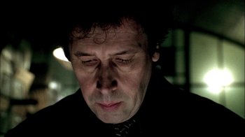 Movie still from “In Dreams” (1999), directed by Neil Jordan – A person wearing a suit and tie; Close Up shot, Low angle