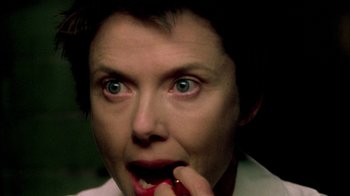 Movie still from “In Dreams” (1999), directed by Neil Jordan – A woman is biting into a red apple; Extreme Close Up shot, Low angle
