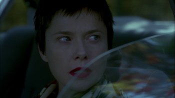 Movie still from “In Dreams” (1999), directed by Neil Jordan – A person holding a umbrella; Close Up shot, Over the shoulder angle