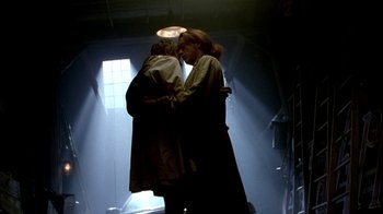 Movie still from “In Dreams” (1999), directed by Neil Jordan – A couple of people that are kissing in a room; Wide shot, Low angle