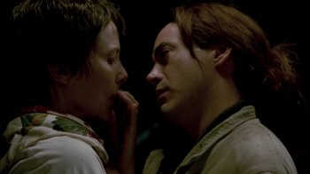 Movie still from “In Dreams” (1999), directed by Neil Jordan – A man and a woman face to face in a dark room; Close Up shot, Low angle