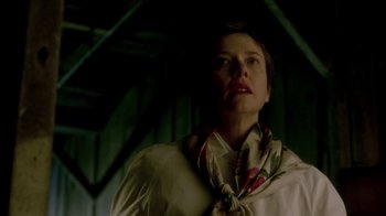 Movie still from “In Dreams” (1999), directed by Neil Jordan – A woman wearing a white shirt and a floral neck scarf; Close Up shot, Low angle