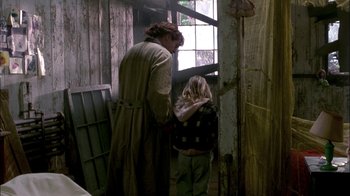 Movie still from “In Dreams” (1999), directed by Neil Jordan – A woman and a child standing next to each other in a room; Medium shot, Over the shoulder angle