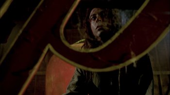 Movie still from “In Dreams” (1999), directed by Neil Jordan – A man looking at himself in a mirror; Close Up shot, Low angle