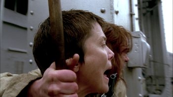 Movie still from “In Dreams” (1999), directed by Neil Jordan – A woman holding a wooden stick in front of another woman; Close Up shot, Low angle
