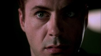 Movie still from “In Dreams” (1999), directed by Neil Jordan – A man's face with green eyes; Extreme Close Up shot, Over the shoulder angle