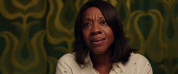 Movie still from “In Fabric” (2018), directed by Peter Strickland – A person wearing a white shirt; Close Up shot, Over the shoulder angle