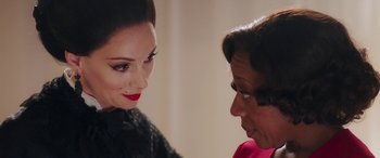 Movie still from “In Fabric” (2018), directed by Peter Strickland – A woman with red lipstick talking to another woman wearing a red shirt; Close Up shot, Over the shoulder angle
