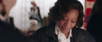 Movie still from “In Fabric” (2018), directed by Peter Strickland – An older woman is looking down at her face; Close Up shot, Over the shoulder angle