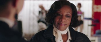 Movie still from “In Fabric” (2018), directed by Peter Strickland – A person wearing a jacket; Close Up shot, Over the shoulder angle