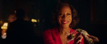 Movie still from “In Fabric” (2018), directed by Peter Strickland – A person wearing a red shirt; Close Up shot, Over the shoulder angle