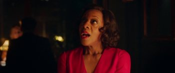 Movie still from “In Fabric” (2018), directed by Peter Strickland – A woman in a red dress looking up at the ceiling; Close Up shot, Over the shoulder angle