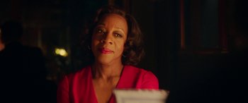 Movie still from “In Fabric” (2018), directed by Peter Strickland – A person sitting in front of a plate; Close Up shot, Over the shoulder angle