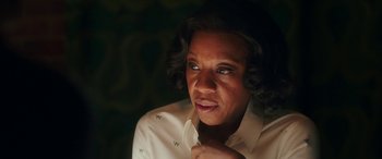 Movie still from “In Fabric” (2018), directed by Peter Strickland – An older woman is looking to her left; Close Up shot, Over the shoulder angle