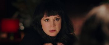 Movie still from “In Fabric” (2018), directed by Peter Strickland – A person with long black hair; Close Up shot, Over the shoulder angle