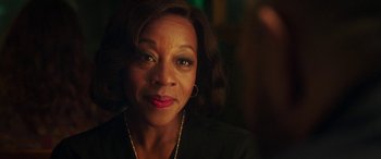 Movie still from “In Fabric” (2018), directed by Peter Strickland – A person wearing a black shirt; Close Up shot, Over the shoulder angle