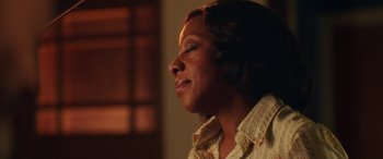 Movie still from “In Fabric” (2018), directed by Peter Strickland – An older woman is looking up into the sky; Close Up shot, Low angle