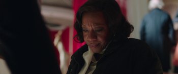 Movie still from “In Fabric” (2018), directed by Peter Strickland – An older woman is looking down at her face; Close Up shot, Over the shoulder angle