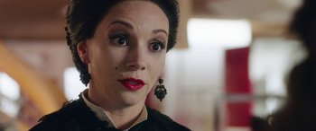 Movie still from “In Fabric” (2018), directed by Peter Strickland – A person wearing a black shirt; Close Up shot, Over the shoulder angle