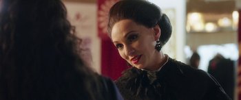 Movie still from “In Fabric” (2018), directed by Peter Strickland – A person wearing a dress; Close Up shot, Over the shoulder angle