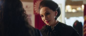 Movie still from “In Fabric” (2018), directed by Peter Strickland – A person wearing a dress; Close Up shot, Over the shoulder angle