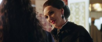 Movie still from “In Fabric” (2018), directed by Peter Strickland – A person wearing a black dress; Close Up shot, Over the shoulder angle