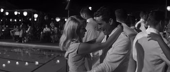 Movie still from “In Harm's Way” (1965), directed by Otto Preminger – A man and a woman dancing together at a party; Medium shot, Low angle