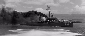 Movie still from “In Harm's Way” (1965), directed by Otto Preminger – A black and white photo of a boat in the water; Wide shot, Low angle